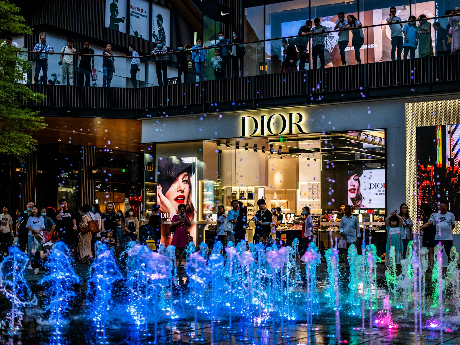 people in a city with blue lights during night time